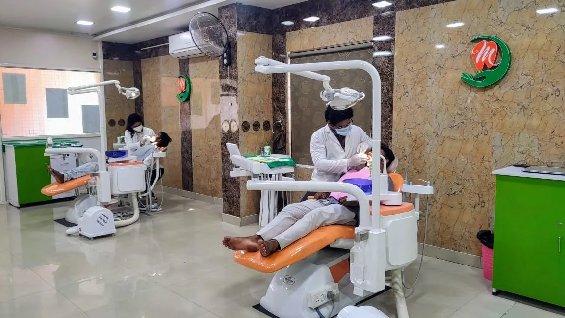 Dr. Ramakrishna Myla MDS performing clinical dental treatment on patient in Guntur operatory