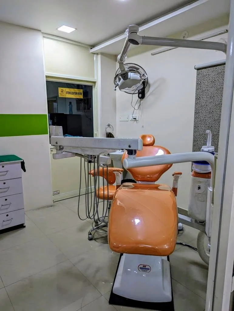 Modern orange ergonomic dental chair with sensor LED operating light at Myla Dental Care